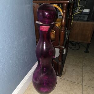 Pink glass vase type thing with a topper